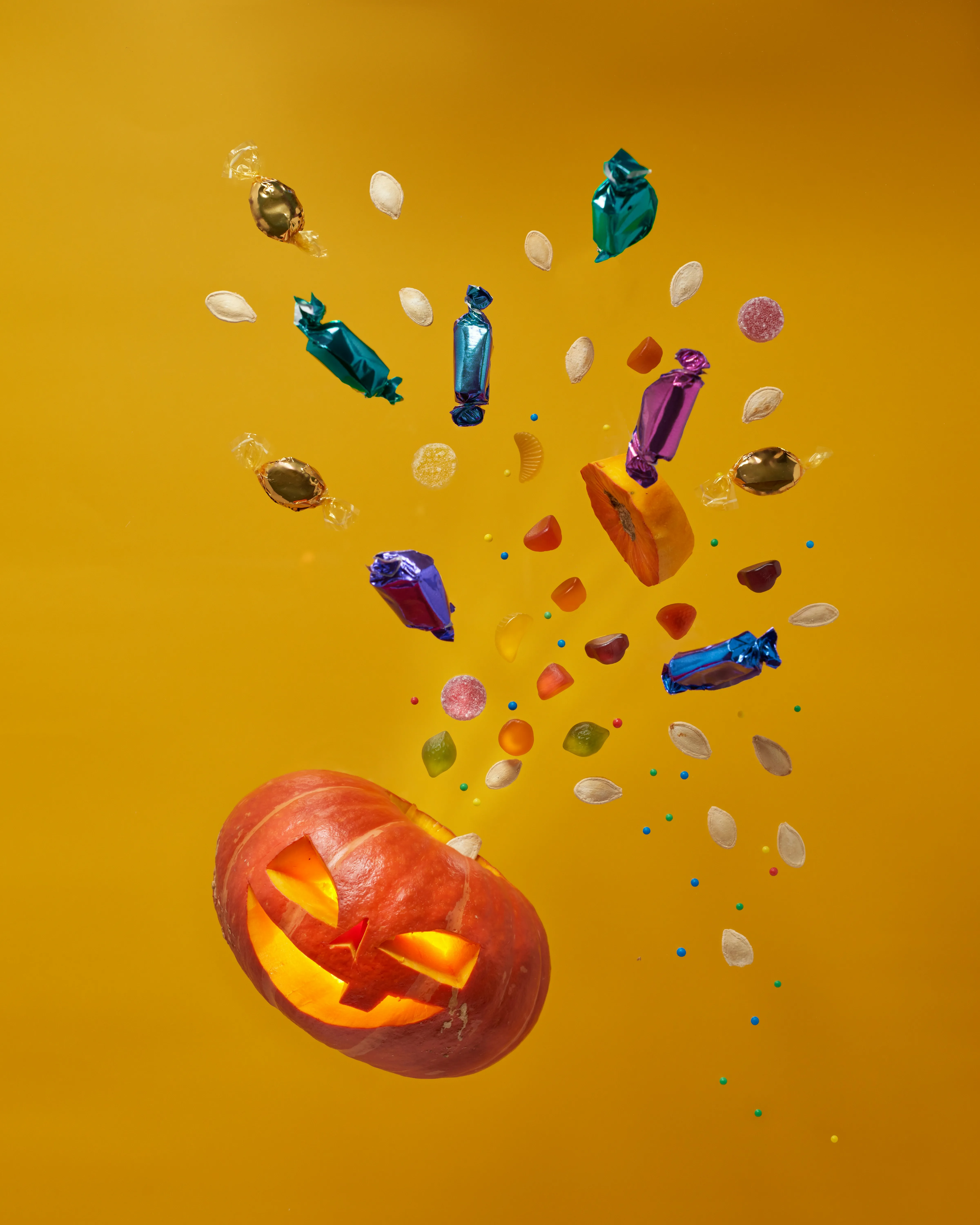 Exploding Pumpkin with Floating Halloween Candy Wallpaper