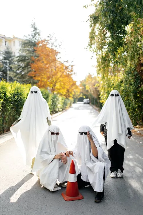 Family in Ghost Costumes for Halloween Festival image
