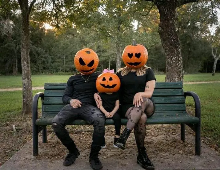 Family in Pumpkin Heads at Halloween Festival Wallpaper