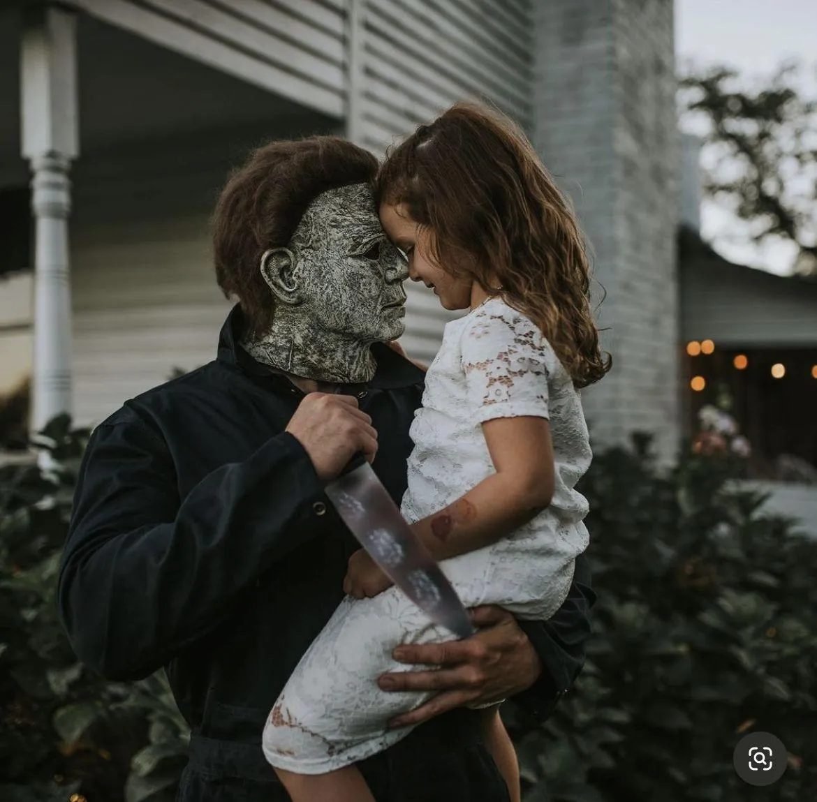Father and Daughter in Halloween Costumes Sharing Moment