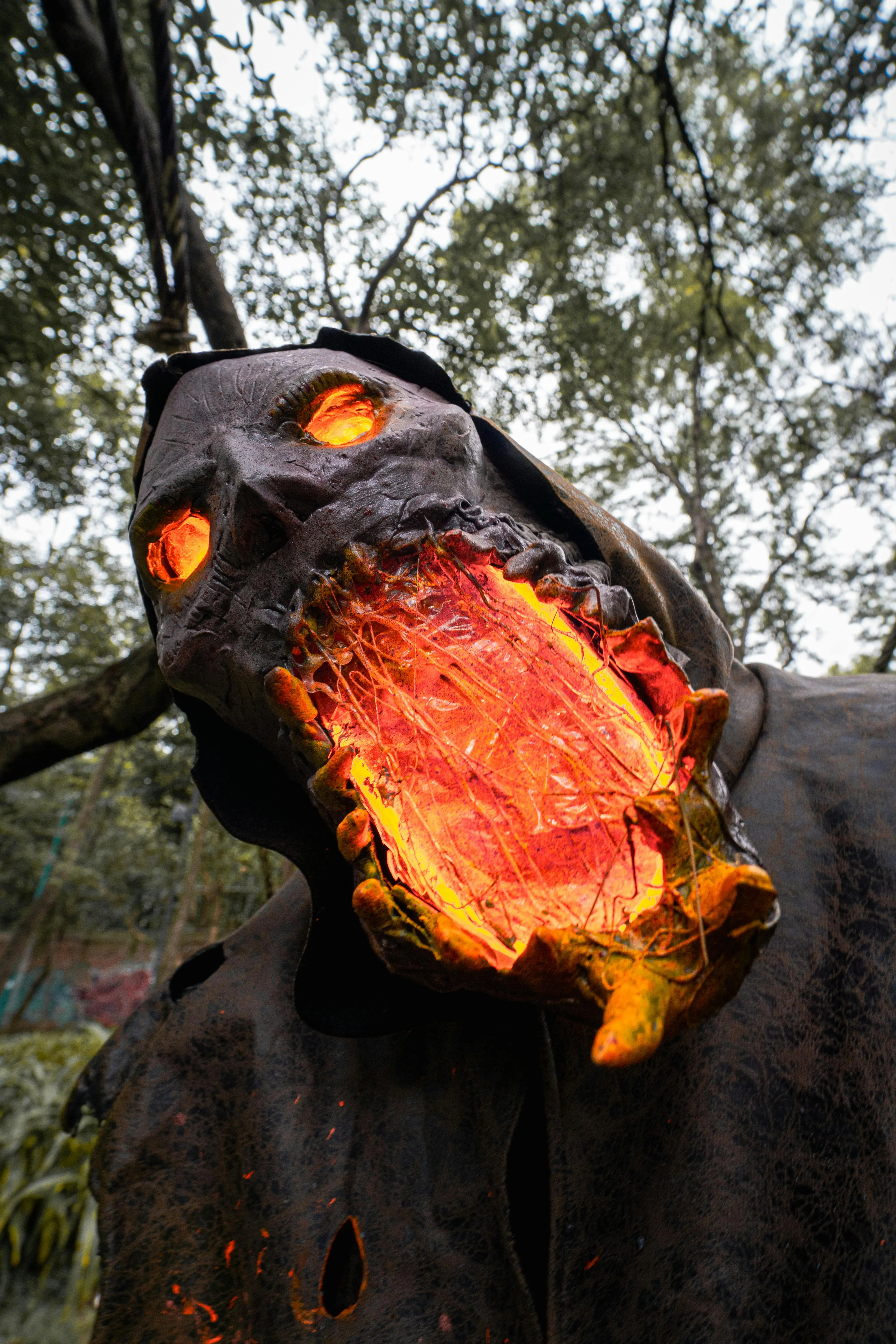 Fiery Halloween Creature with Dramatic Costume at forest