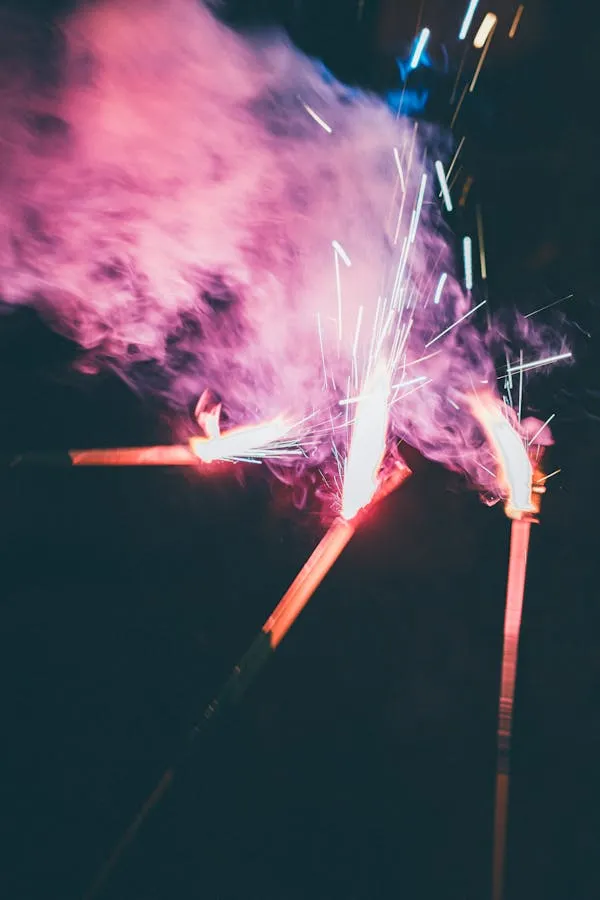 Fiery Pink and Purple Firework Bursts Against a Dark Sky