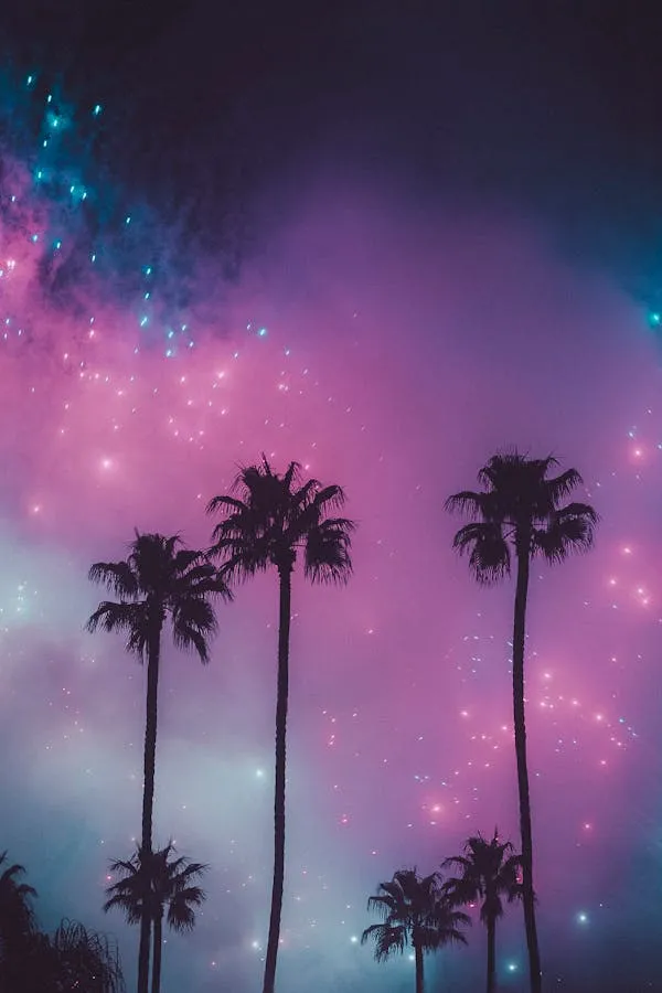 Fireworks Behind Palm Trees with Pink and Blue Hues