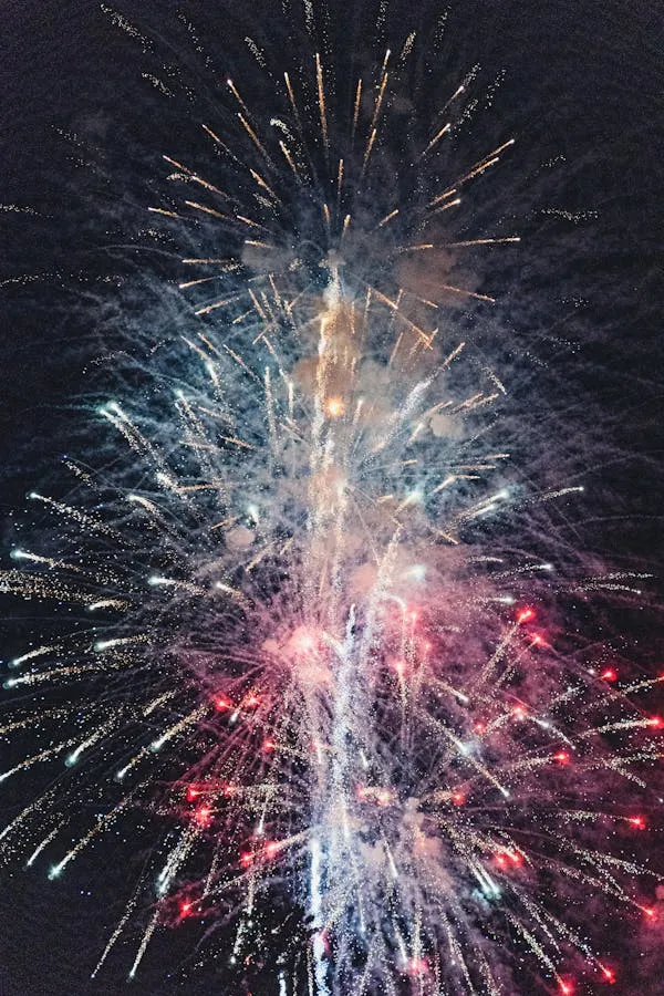 Fireworks bursting beautifully in multiple directions at night