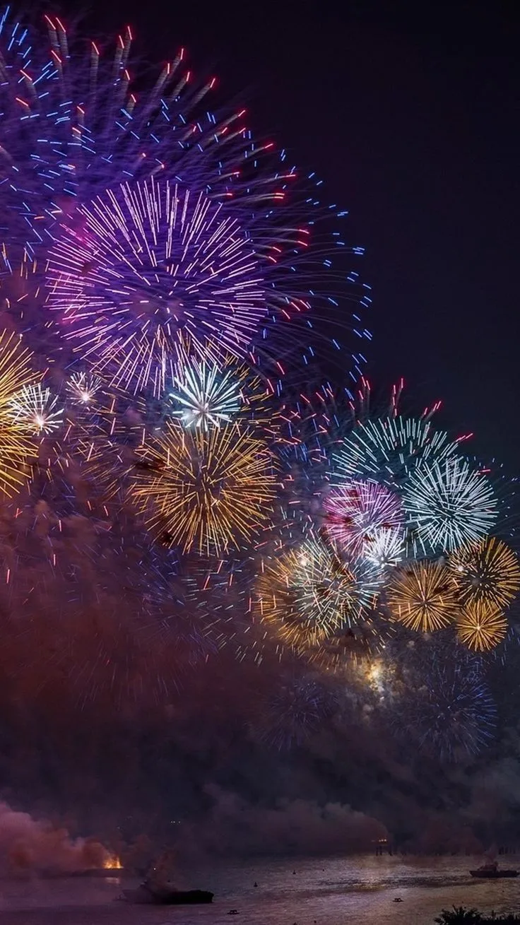 Fireworks bursting in Colourful over a dark night sky HD