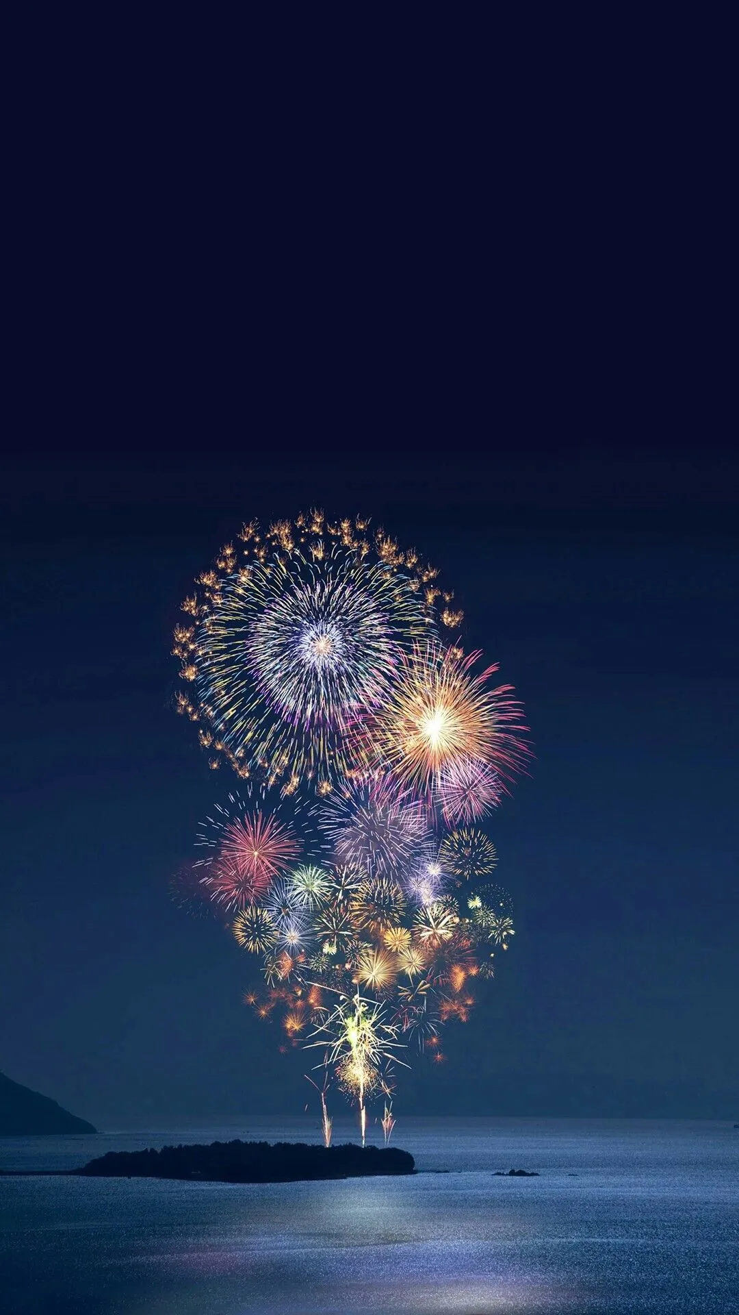 Fireworks creating a beautiful display over the dark landscape