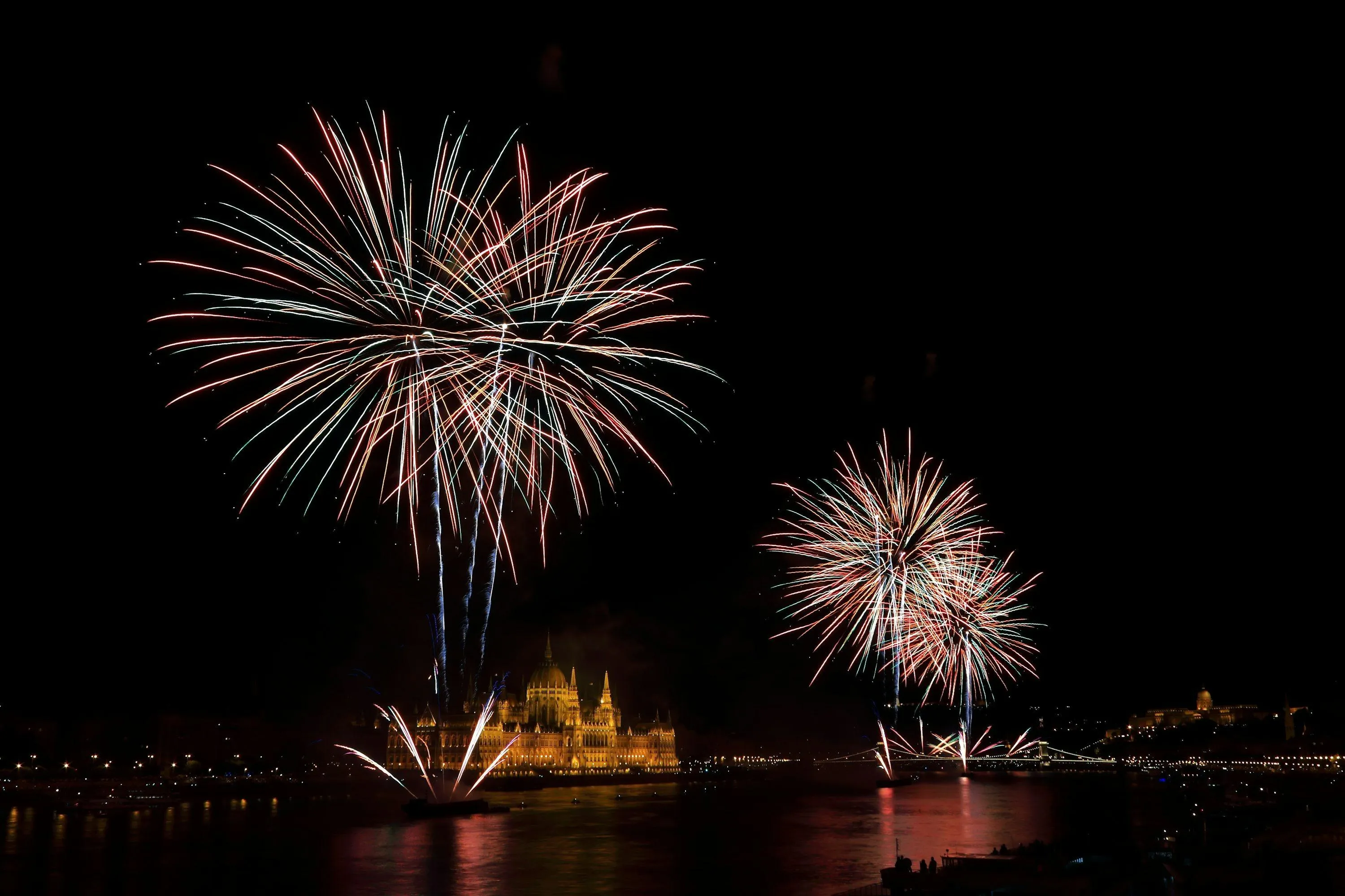 Fireworks Exploding in Bright Patterns over a Waterbody
