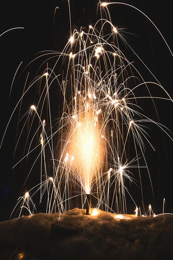 Fireworks exploding with sparks lighting up the night sky