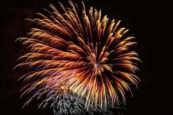 Fireworks filling the sky in a brilliant explosion 4K Wallpaper