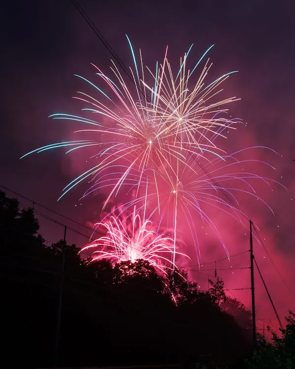 Fireworks Lighting up the Sky over a Mountain Wallpaper