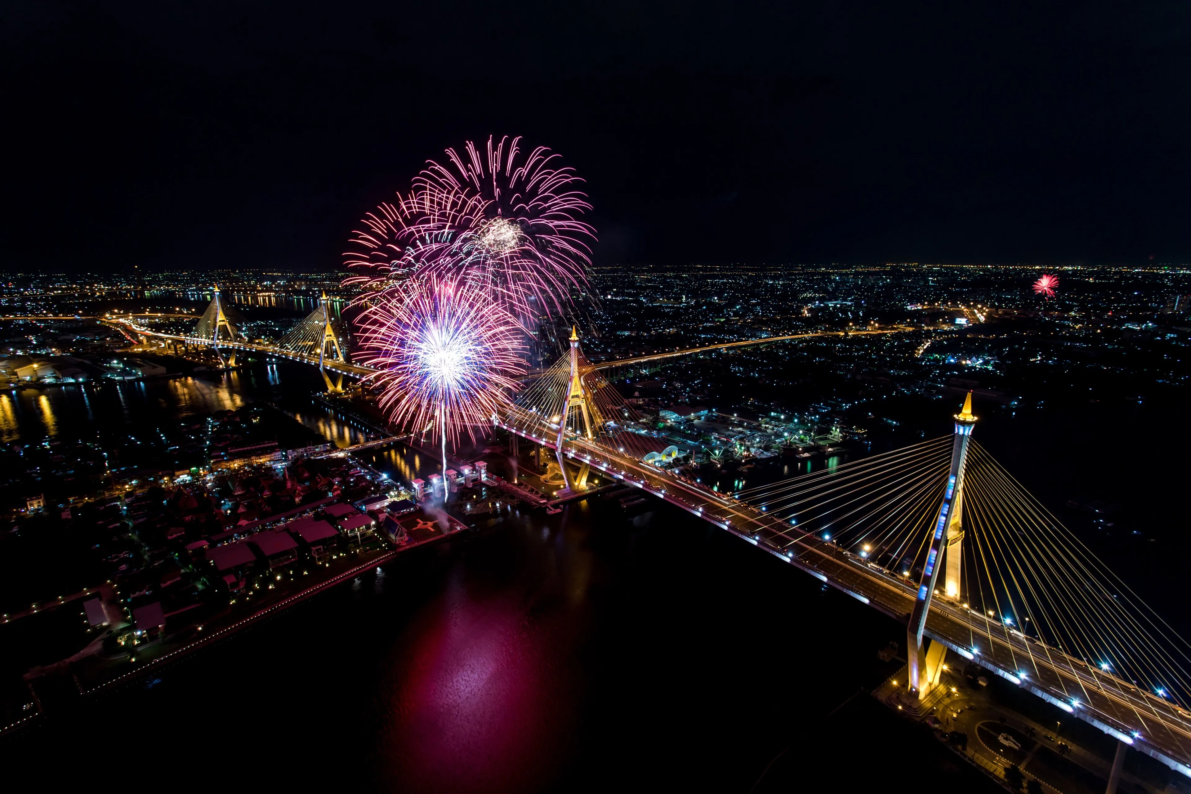 Fireworks over City Skyline Near Iconic Landmarks Wallpaper