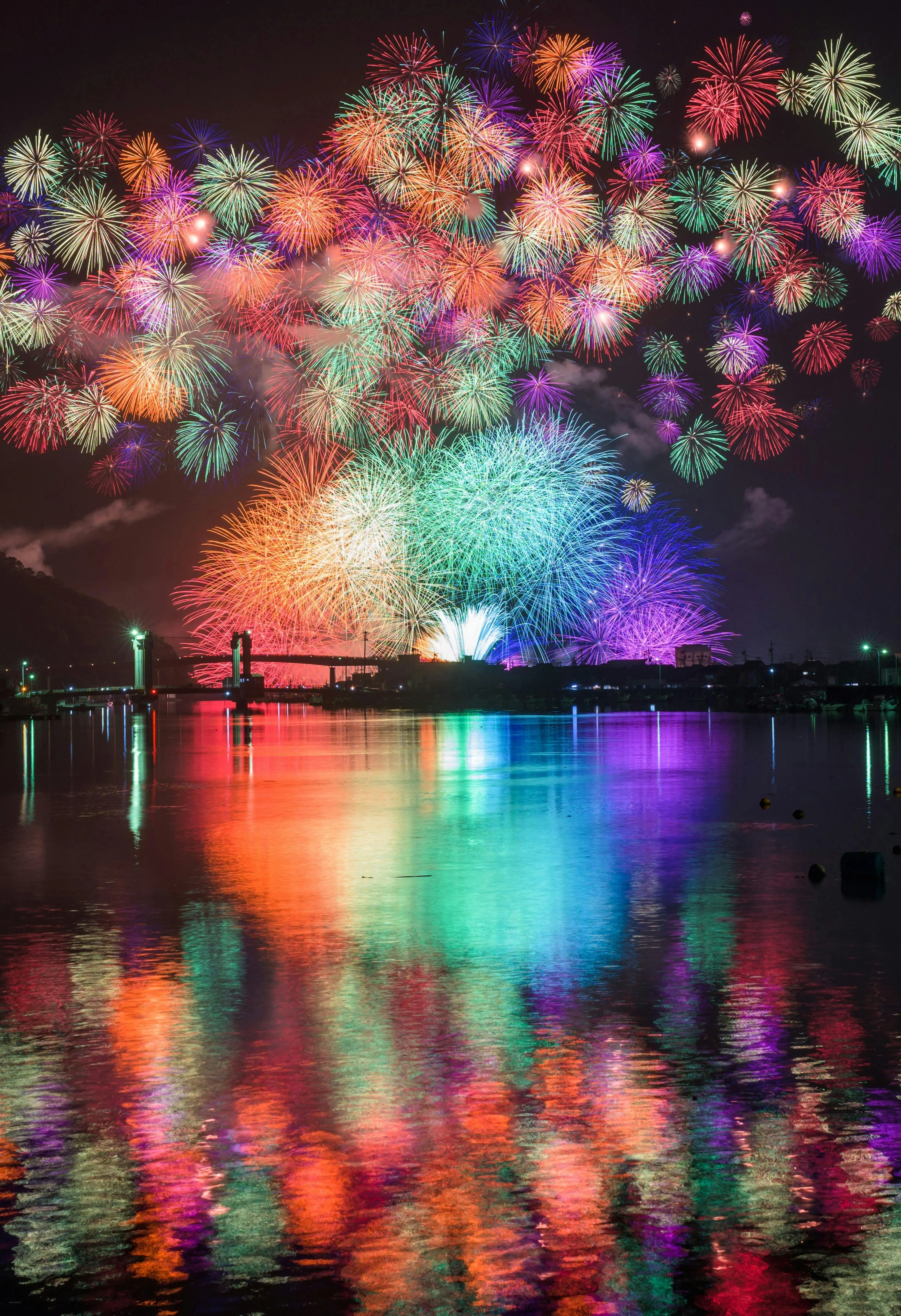 Fireworks Reflected in Water During a City Celebration
