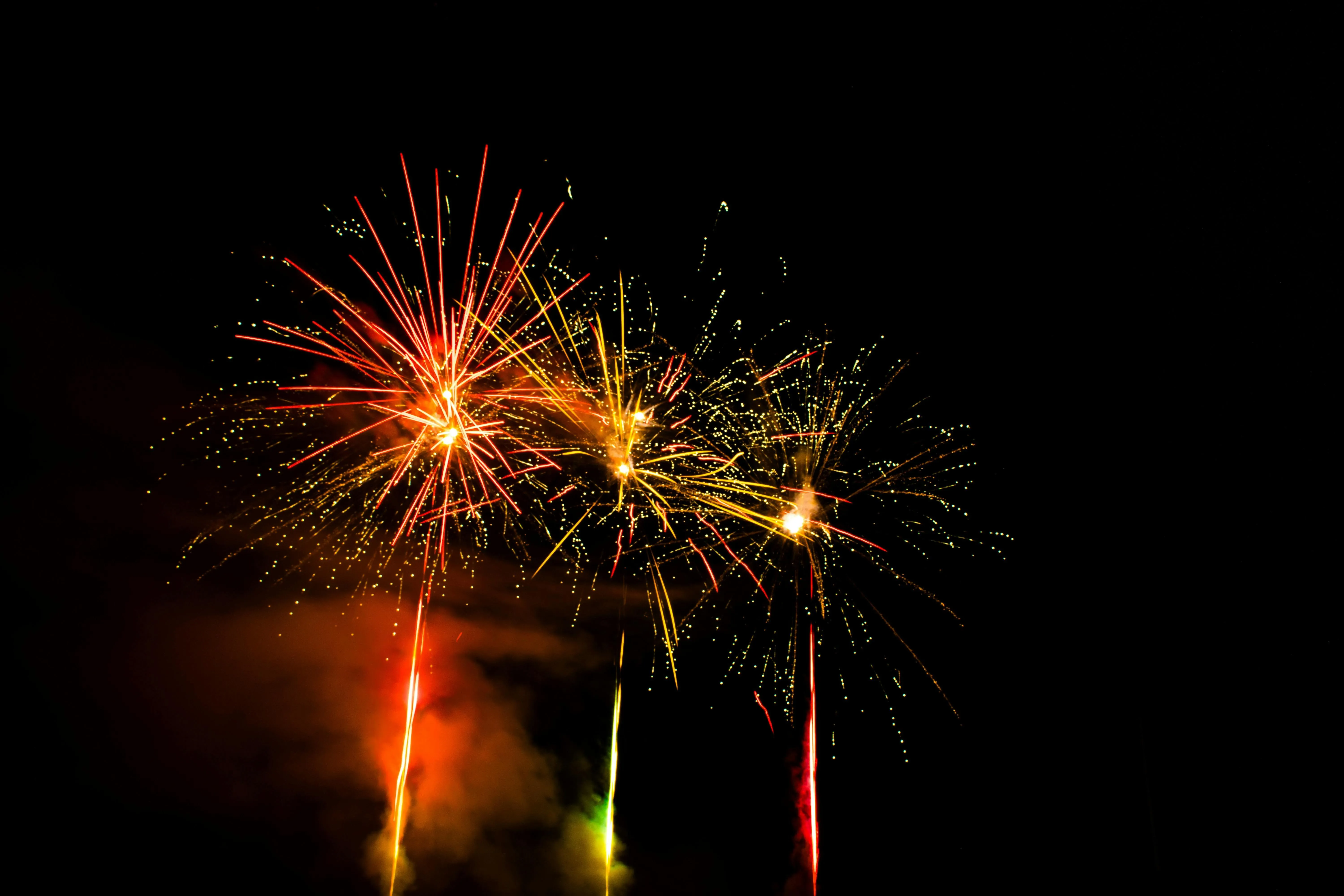 Fireworks with a dramatic display of red and yellow