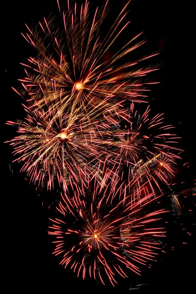 Fireworks with red and gold colors creating a stunning scene