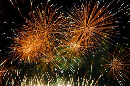 Fireworks with Vibrant Yellow and Orange Trails Wallpaper