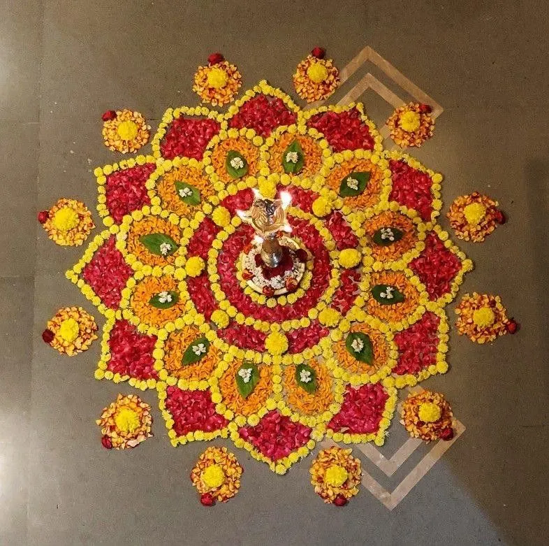 Floral Athapookolam with colourful petal layers and a lamp