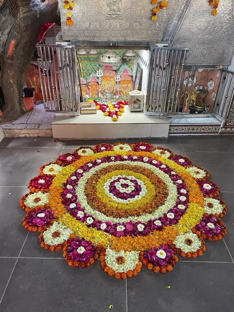 Floral circular rangoli with flower petal design for temple