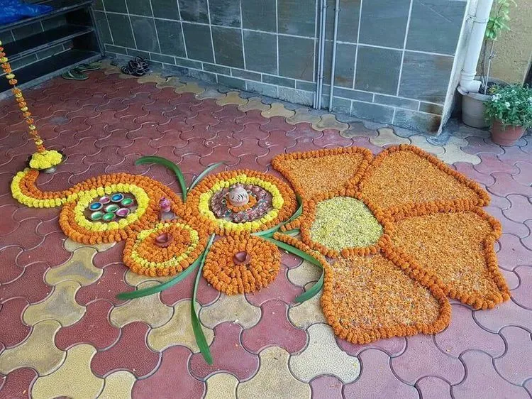Flower pattern Onam pookolam with decorative oil Lamps image
