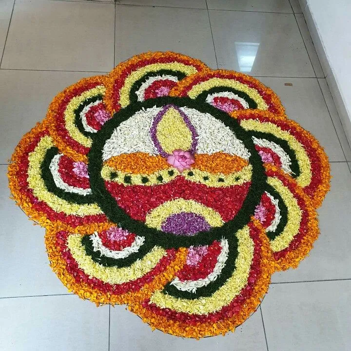 Flower pookolam with Diya design for Onam Decoration