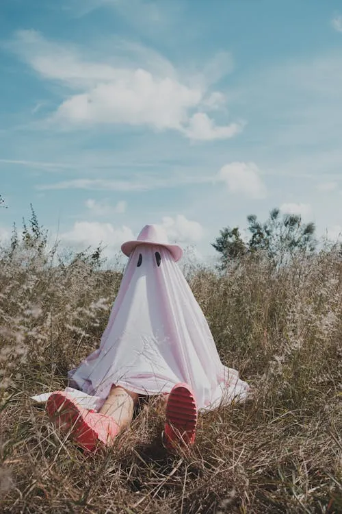 Ghostly Figure in White Dress at Halloween Festival