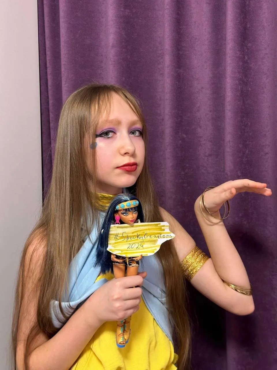Girl Holding Disney toy with Makeup and Long Hair image