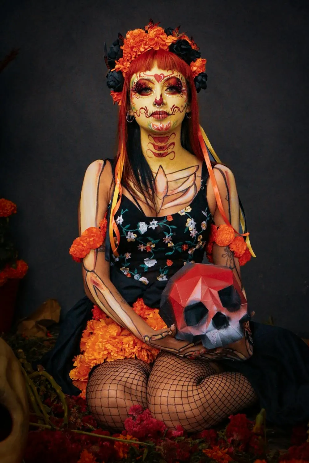 Girl in Day of the Dead Costume Holding Skull Doll image