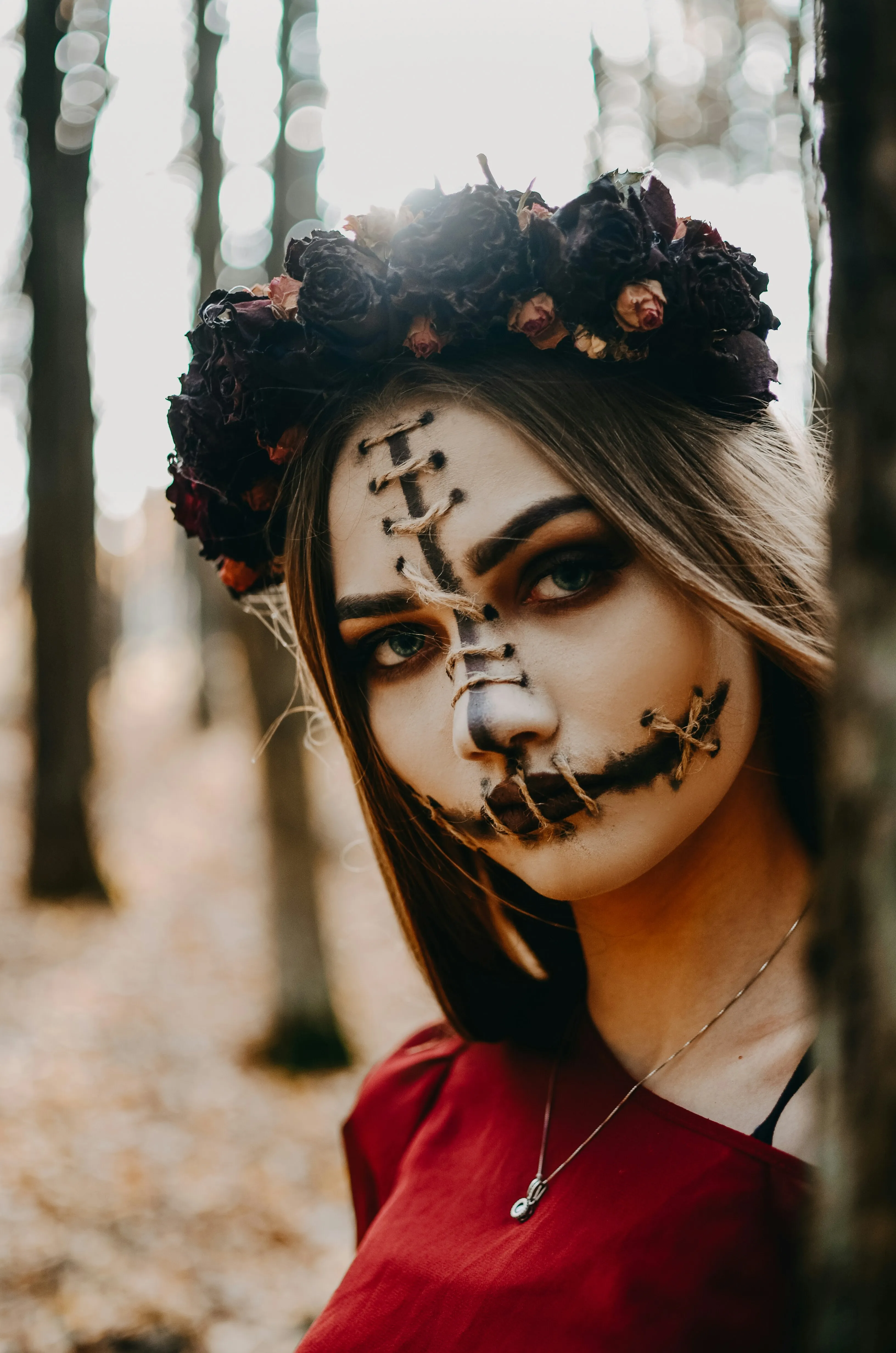 Girl in Red Dress Wearing Dotted Skull Face Paint Wallpaper