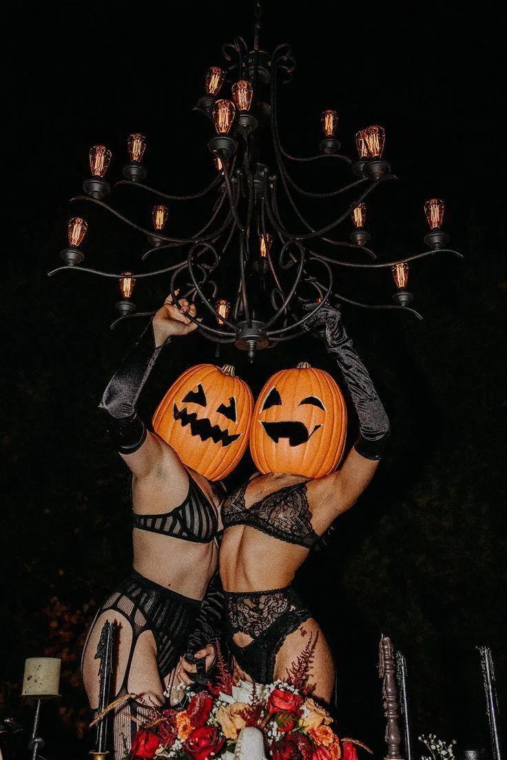 Girls Wearing Pumpkin Head Masks at Halloween Party image