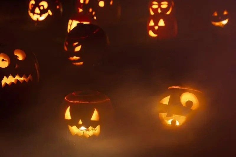 Glowing Jack O Lanterns in Dimly Lit Night Scene Wallpaper