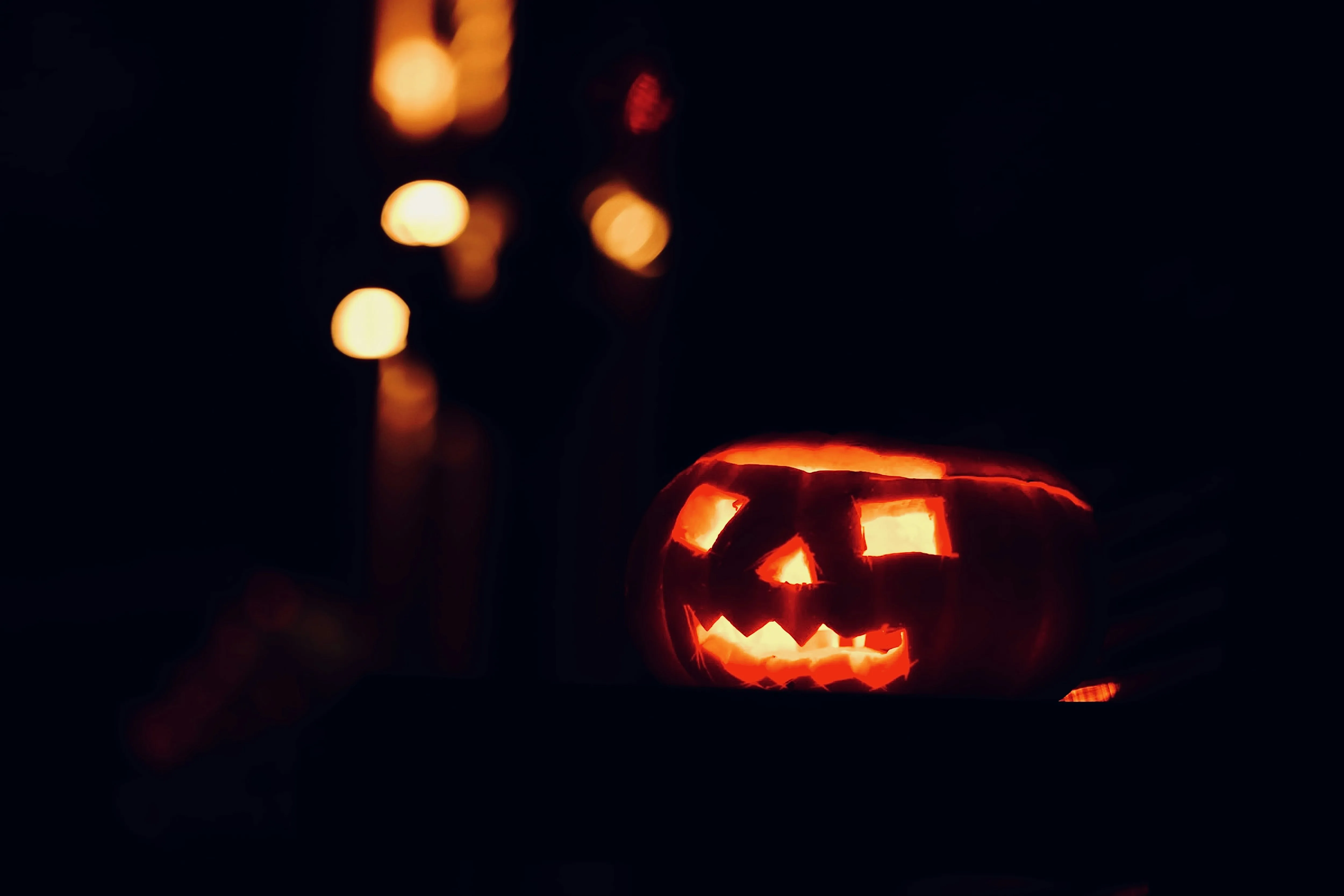 Glowing Pumpkin Face in a Dimly Lit Halloween Scene Image
