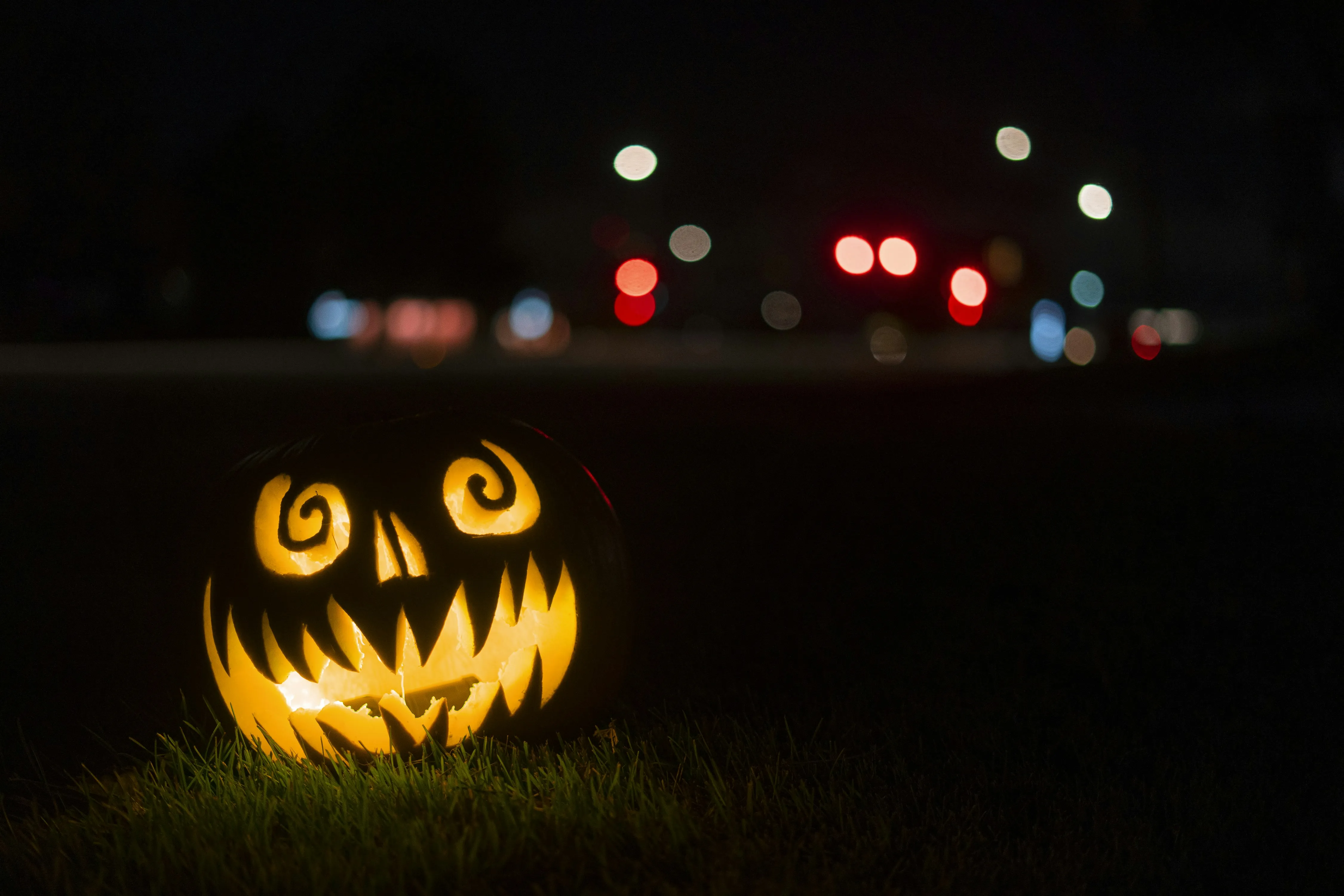 Glowing Pumpkin in Night with Colourful Bokeh Lights 4K