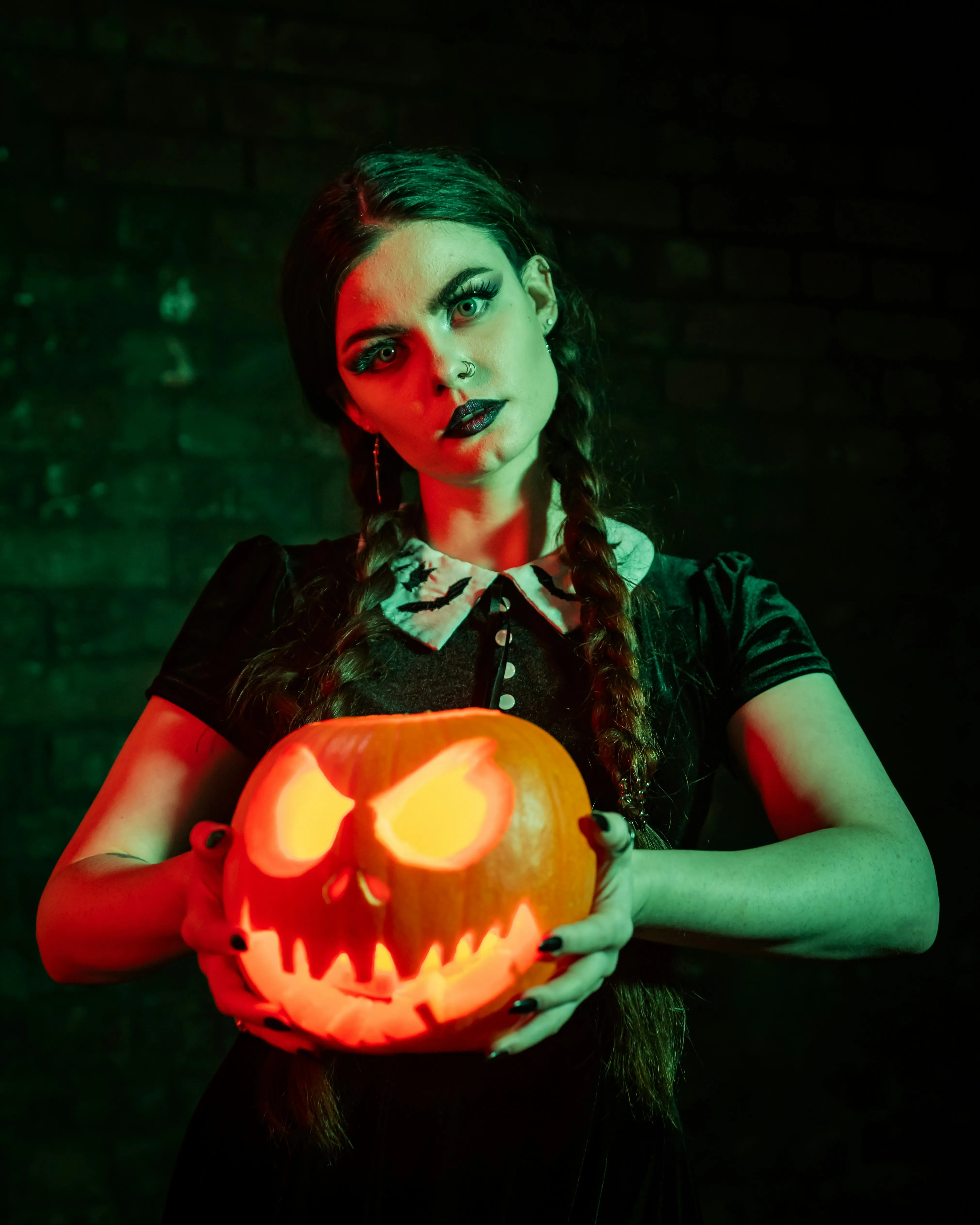 Gothic Girl Holding Pumpkin in Halloween Glow Wallpaper
