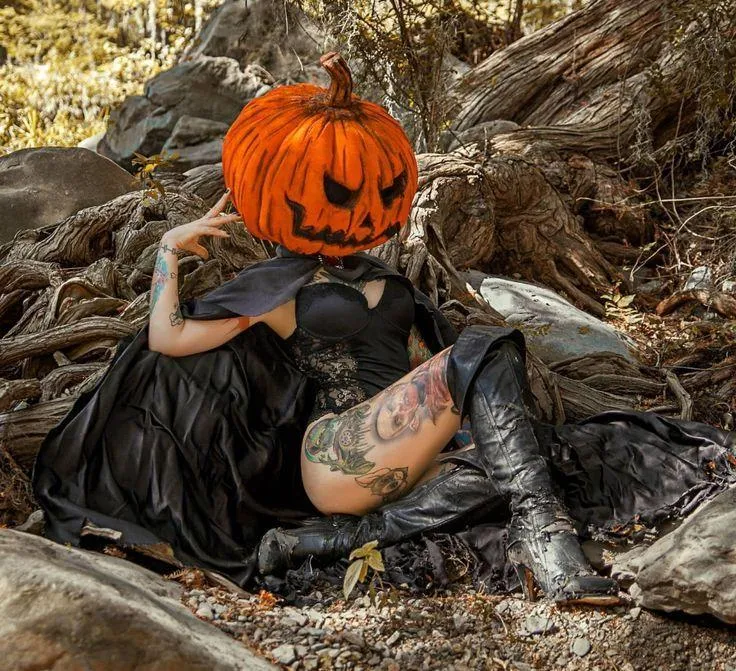 Gothic Pumpkin Head Costume with Tattoo Art at Festival