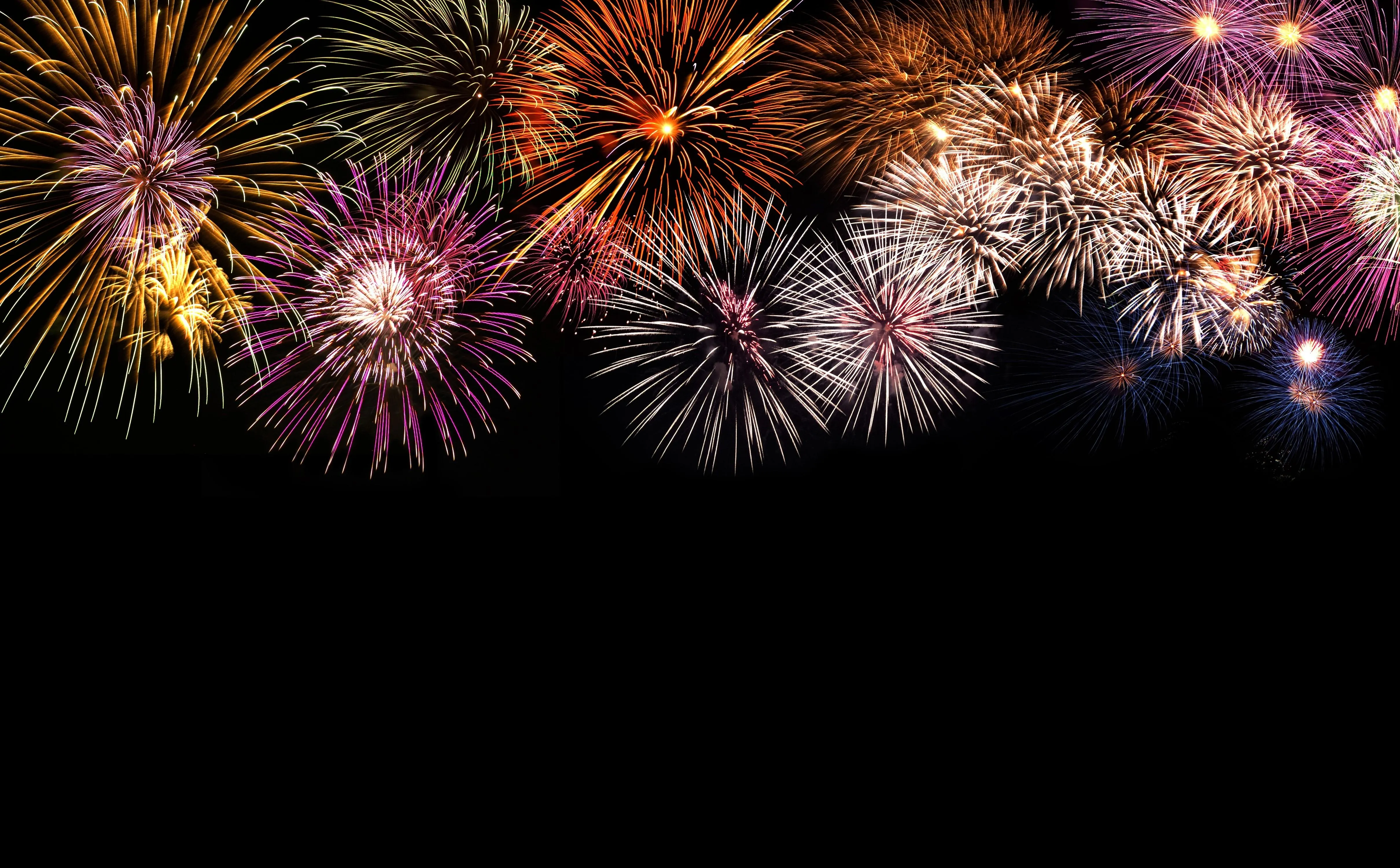 Grand Fireworks Display over City Skyline at Night Wallpaper