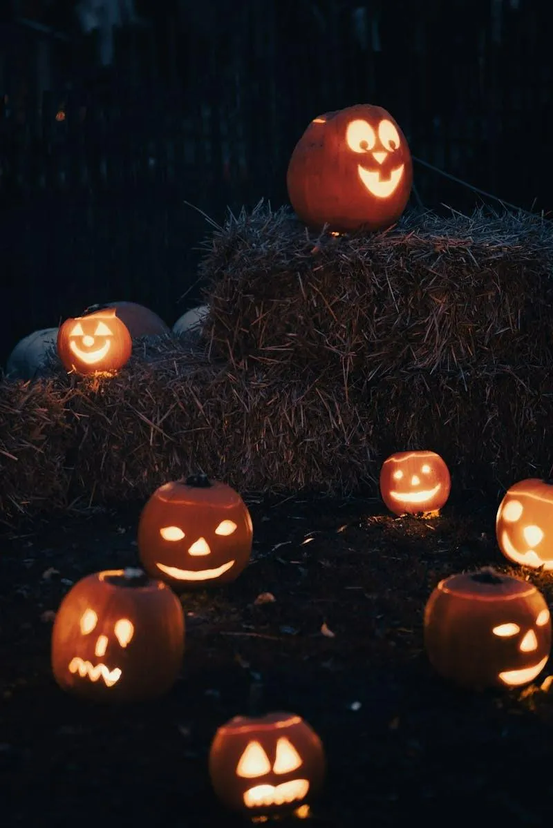 Group Of Glowing Jack O Lanterns on Hay Bale Wallpaper