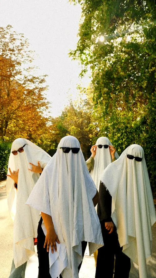 Group of People Wearing Ghost Costumes Outdoors Wallpaper