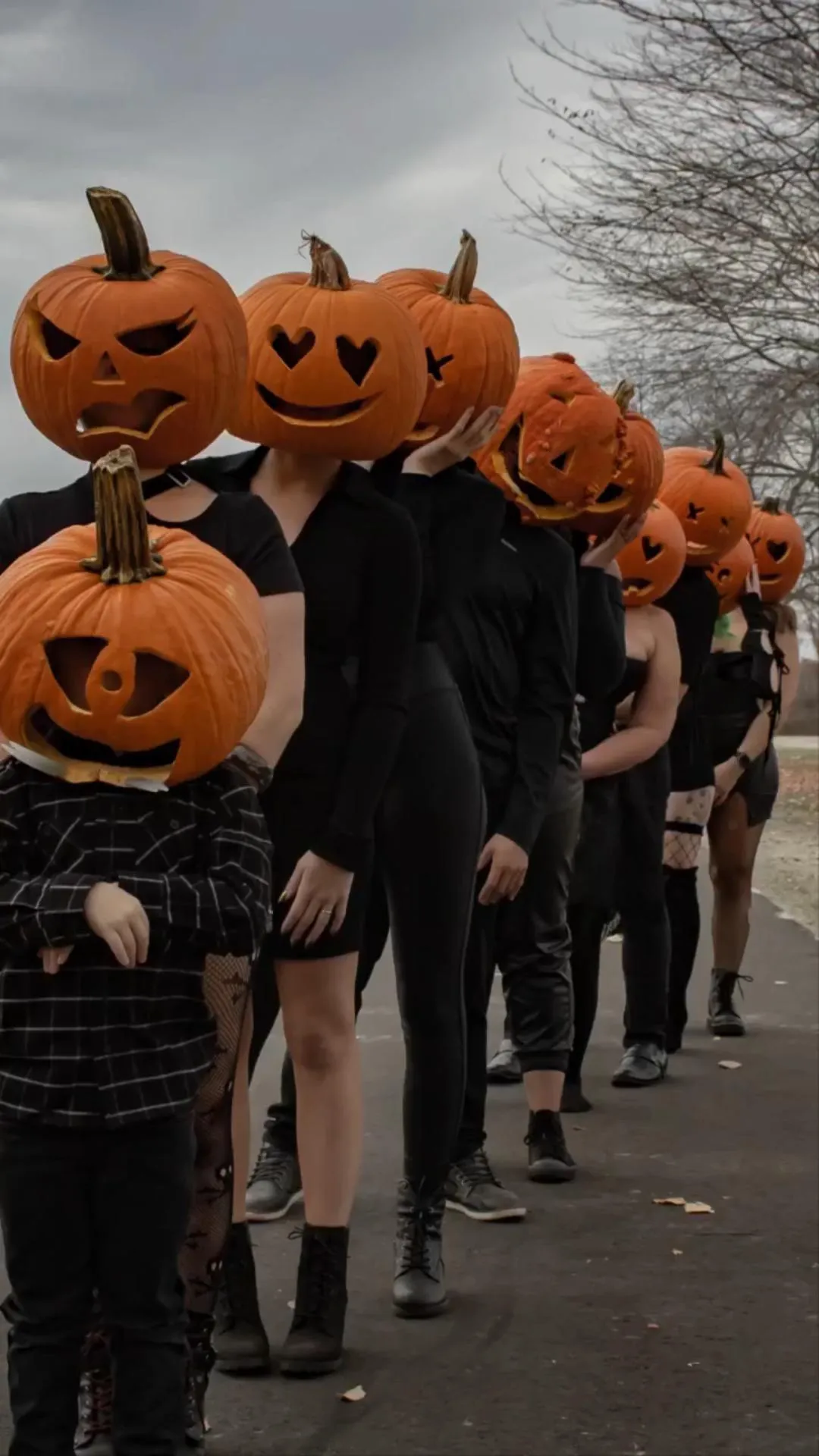 Group Parade in Pumpkin Heads on Halloween Day Wallpaper