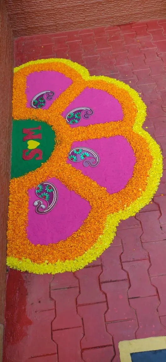 Half flower design pookolam with yellow and orange petals