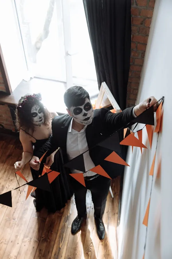 Halloween couple hanging banners in skull makeup image