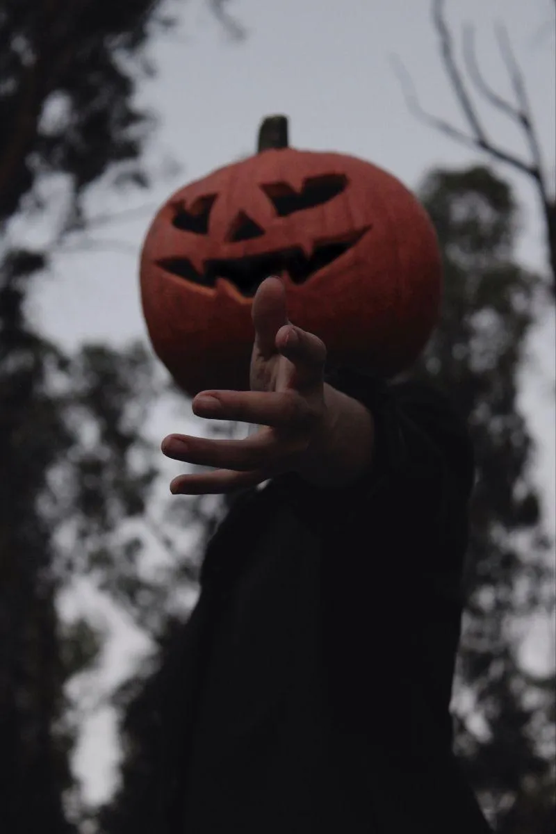 Halloween Festival Person with Pumpkin Head Reaching Forward