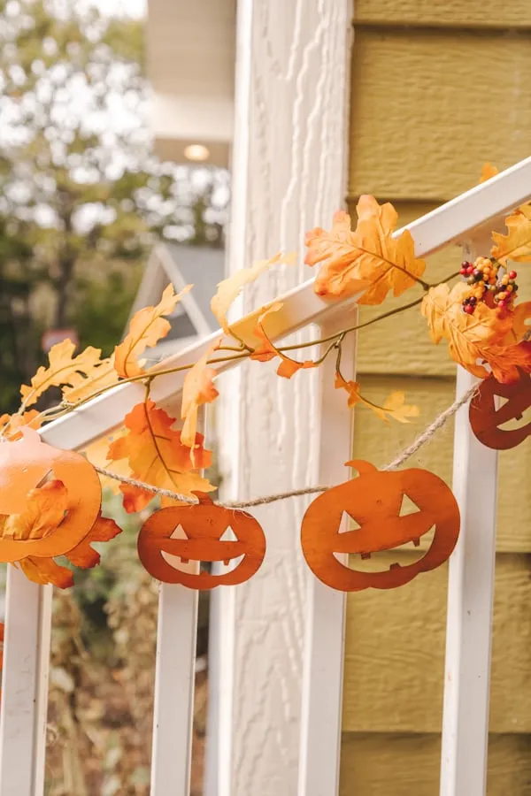 Halloween Garland with Pumpkin Faces on Porch Railing HD