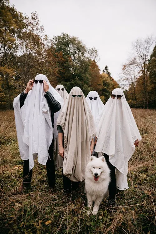 Halloween Group in Ghost Costumes Walking with a Dog