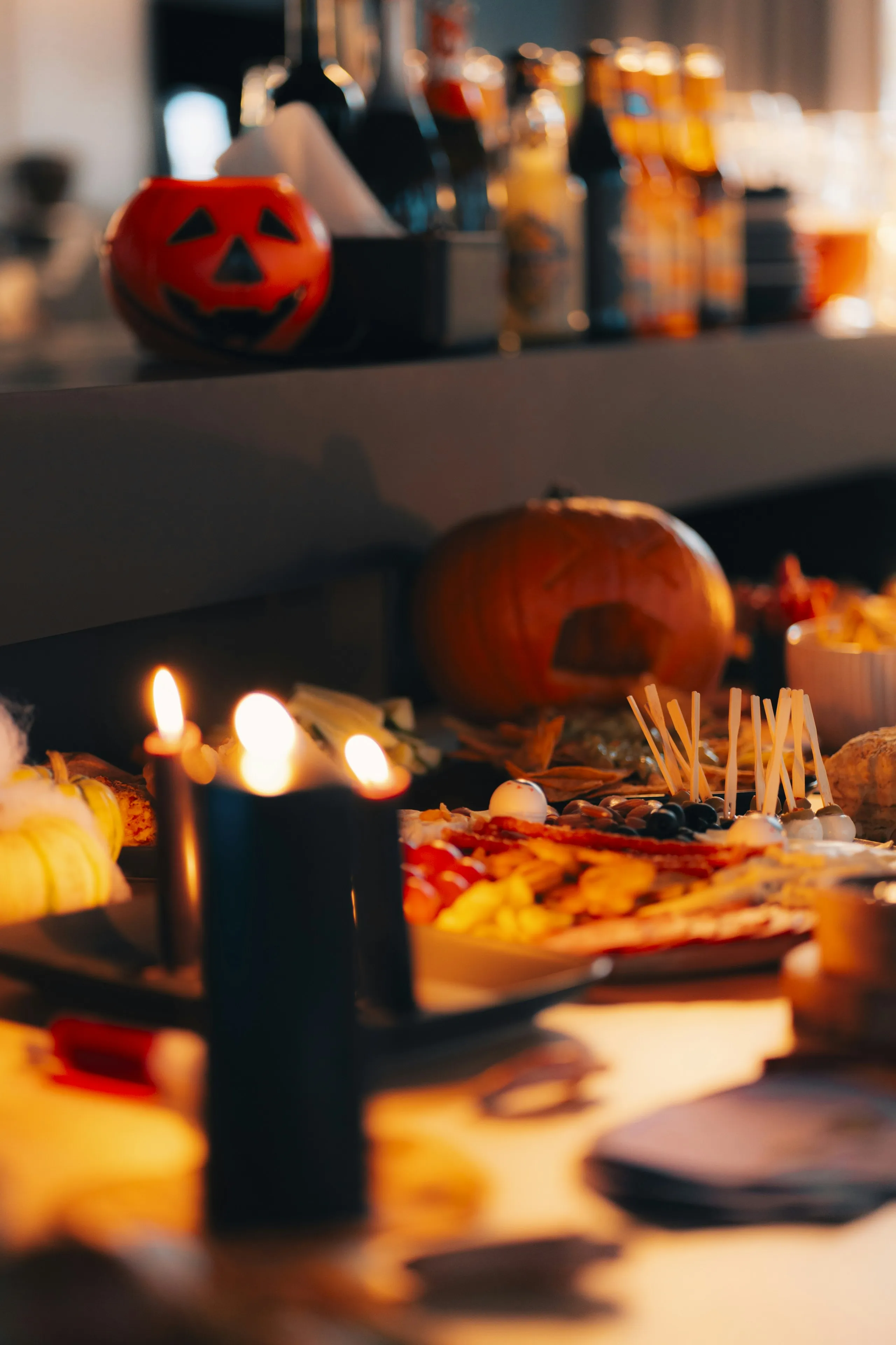 Halloween Party Table with Pumpkins and Candles Wallpaper
