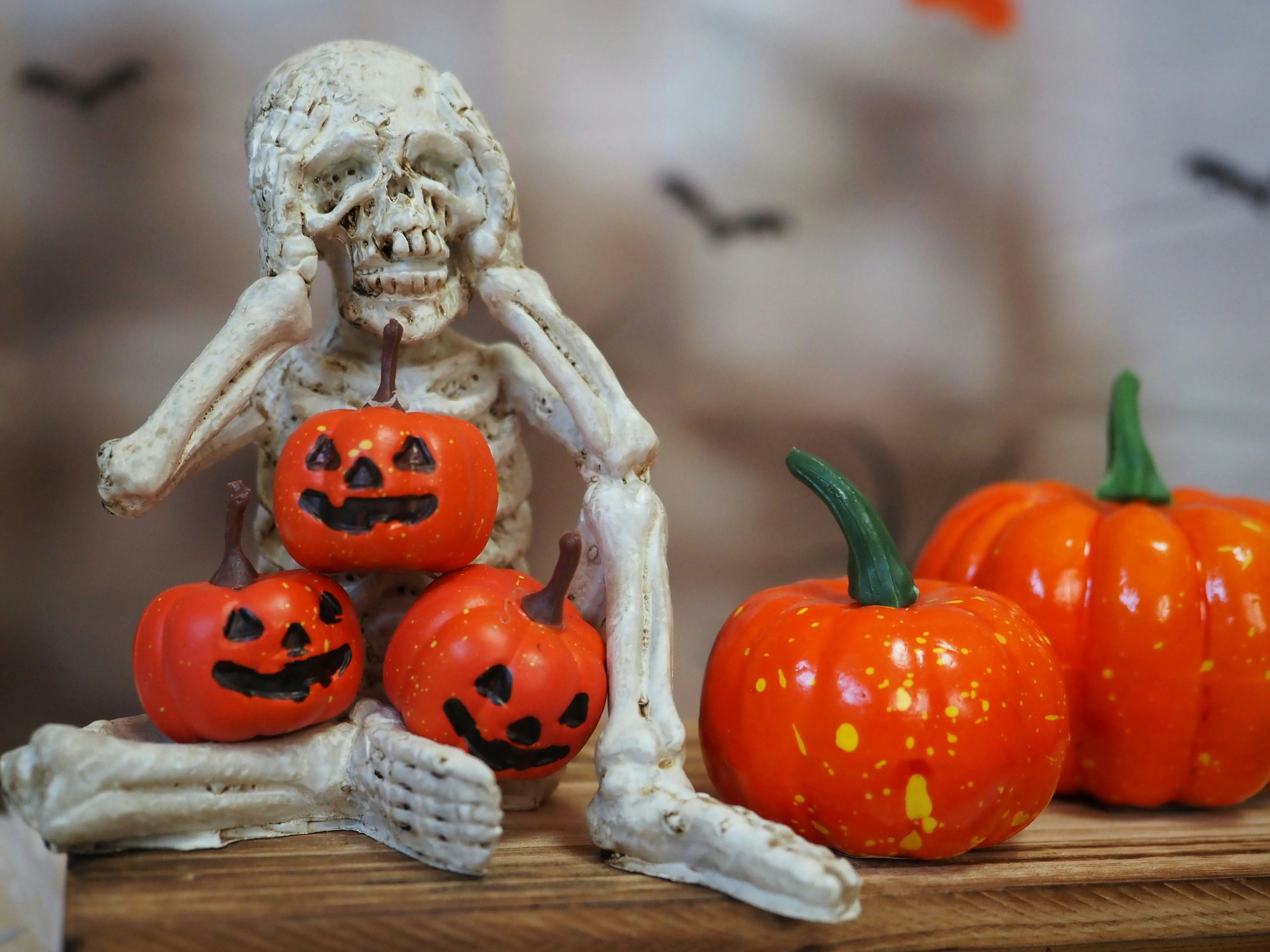 Halloween Skeleton with Pumpkins on Wooden Table Wallpaper