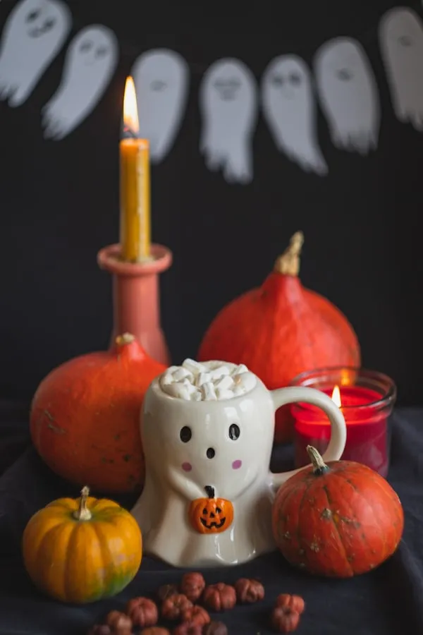 Halloween Table Decor with Candles and Pumpkins Wallpaper