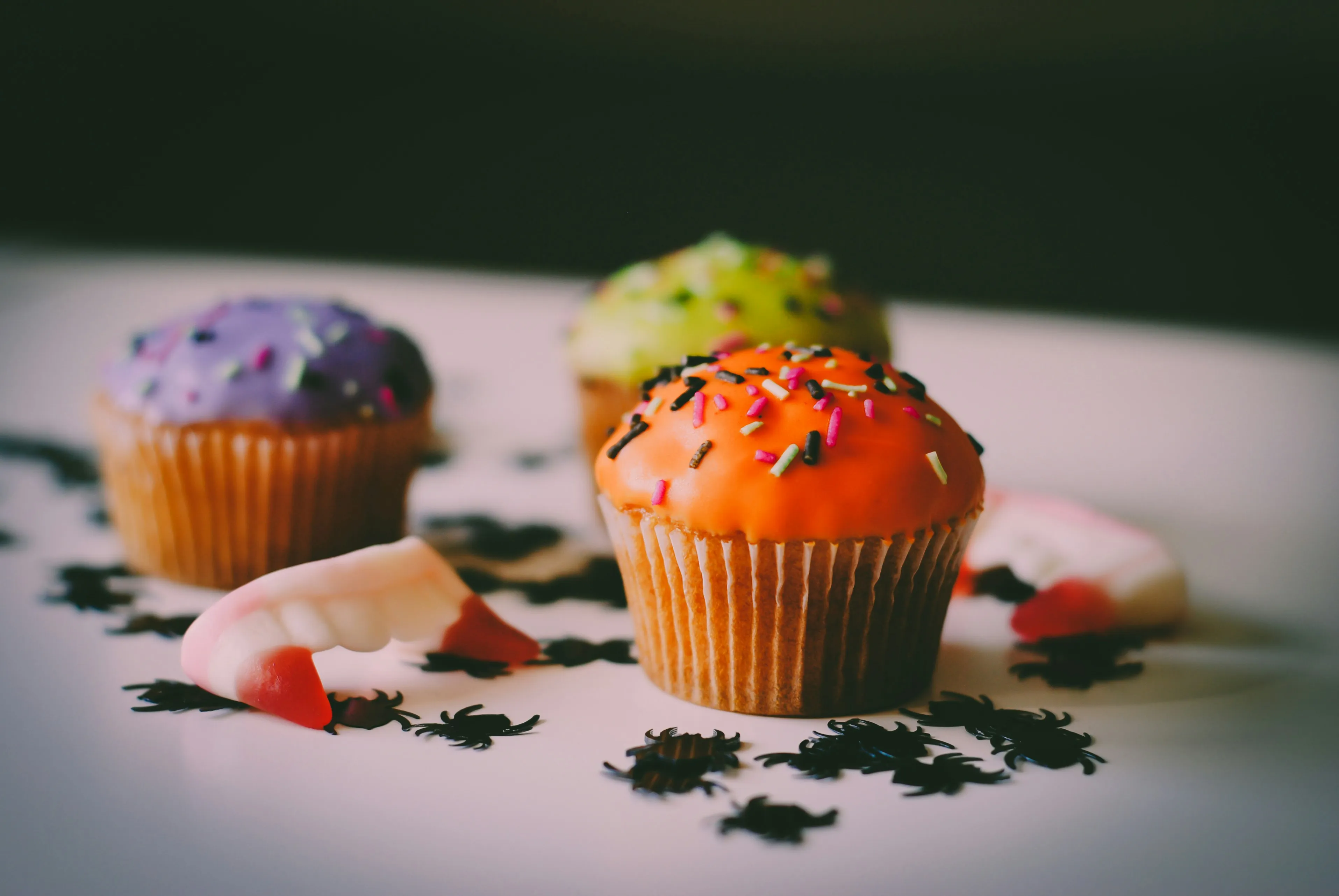 Halloween Themed Cupcakes with Pumpkin and Spider Decorations