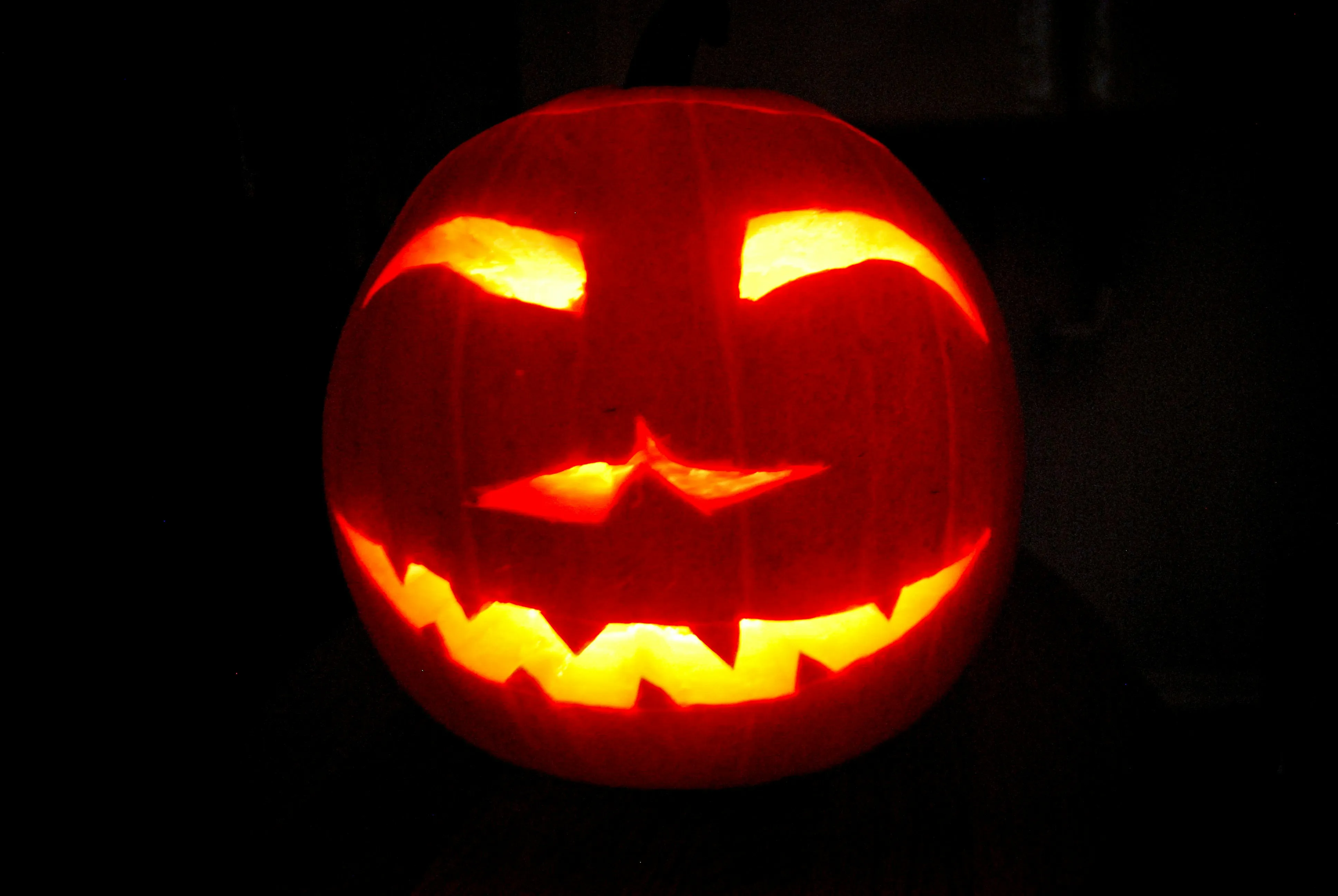 Happy Carved Jack O Lantern Glowing at Night Free HD Image
