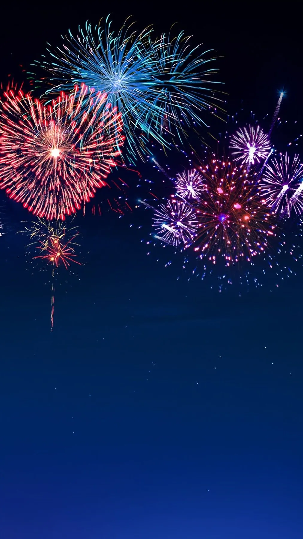 Heart shaped fireworks glowing in the dark sky Wallpaper