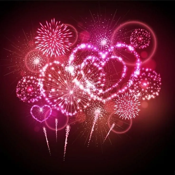 Heart Shaped Fireworks in Pink and Red Exploding in the Sky