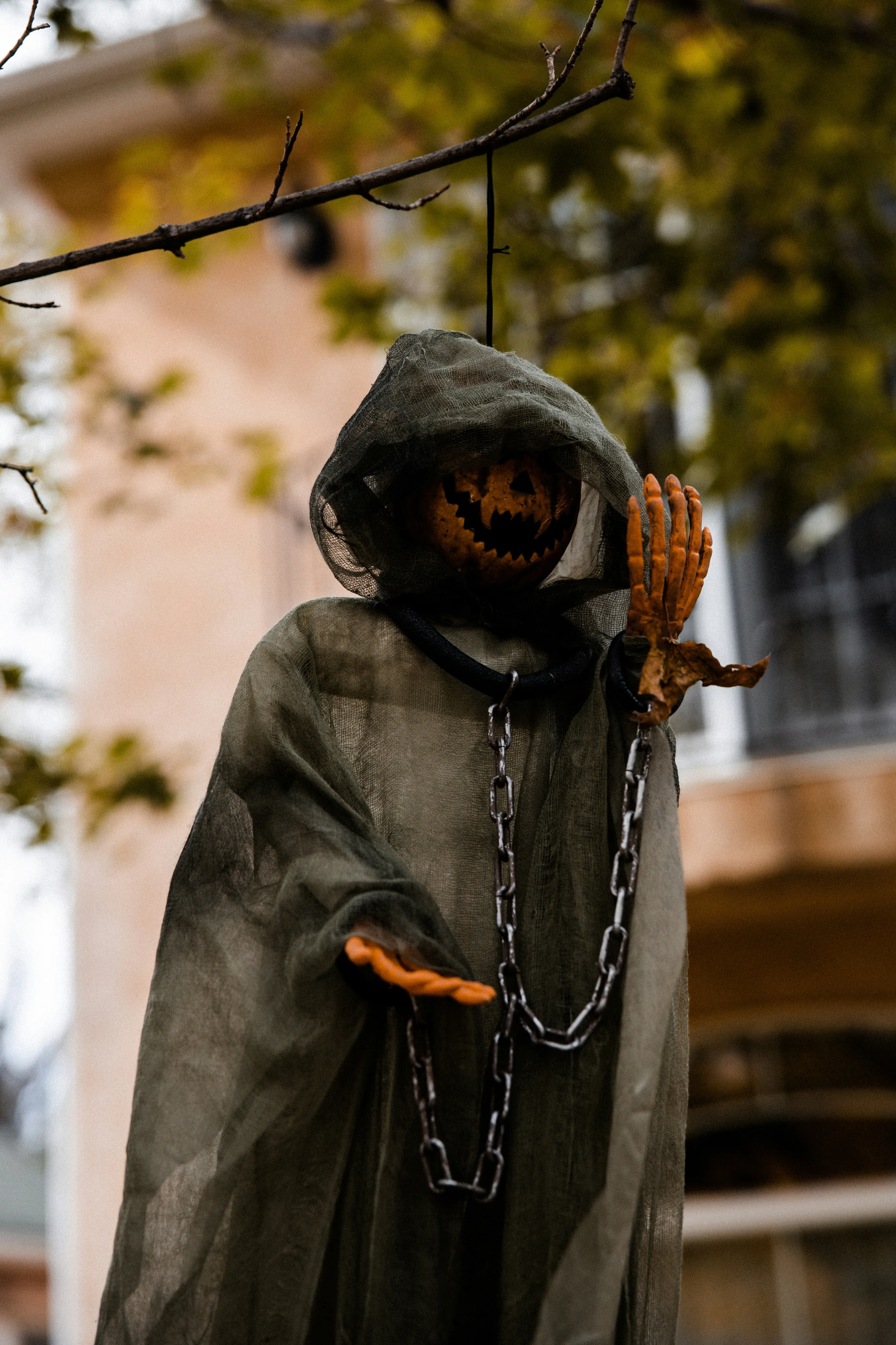 Hooded Figure with Pumpkin Lantern face at Festival